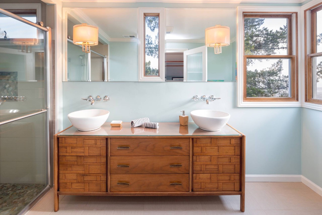 Wooden vanity with two round sinks in a summer blue bathroom at Midwest Blind & Shades near Mishawaka, IN P