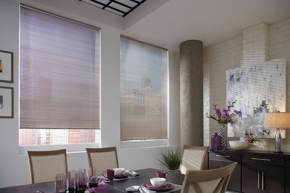 Elegant apartment dining room with Hunter Douglas Precious Metals® Mini Blinds decorating two windows at Midwest Blind & Shades near Mishawaka, IN