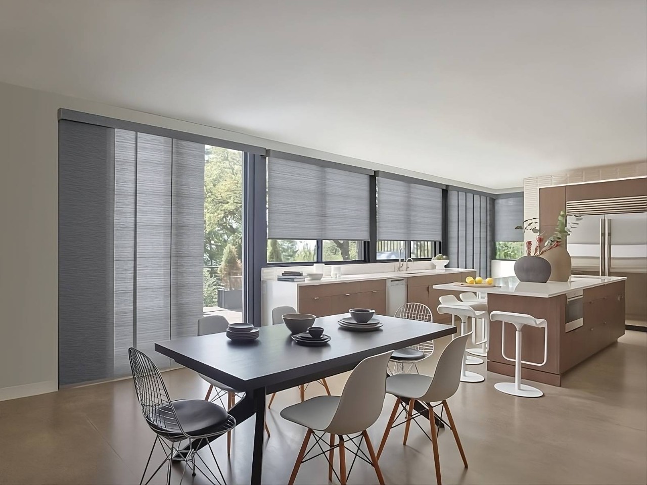 Hunter Douglas roller shades on a sliding glass door in a kitchen with matching window treatments at Midwest Blind & Shade near Mishawaka, IN
